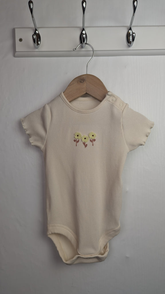 M&S Cream Ribbed Floral Bodysuit - Girls 9-12 Months Little Ones Preloved Used, Preloved, Preworn & Second Hand Baby, Kids & Children's Clothing UK Online. Cheap affordable. Brands including Next, Joules, Nutmeg Morrisons, TU, F&F, H&M.