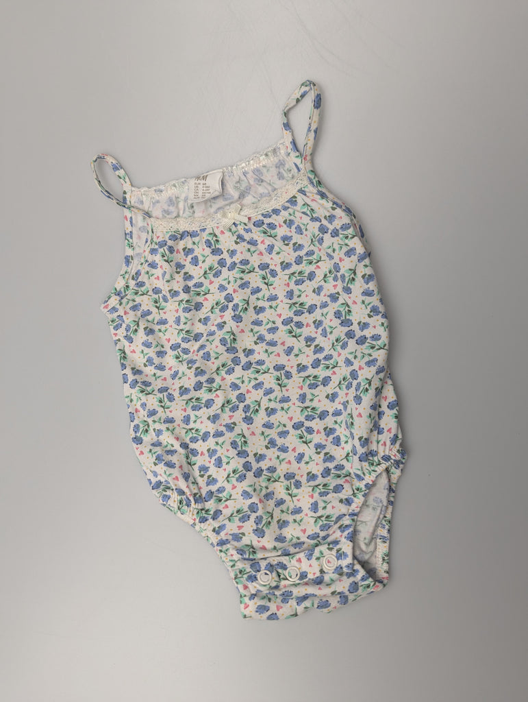 H&M Blue Floral Bodysuit - Girls 4-6 Months Little Ones Preloved Used, Preloved, Preworn Baby, Girls & Boys Clothes. Kids & Children's second hand Clothing UK Online. Cheap affordable. Brands including Next, Joules, Nutmeg Morrisons, TU, F&F, H&M.