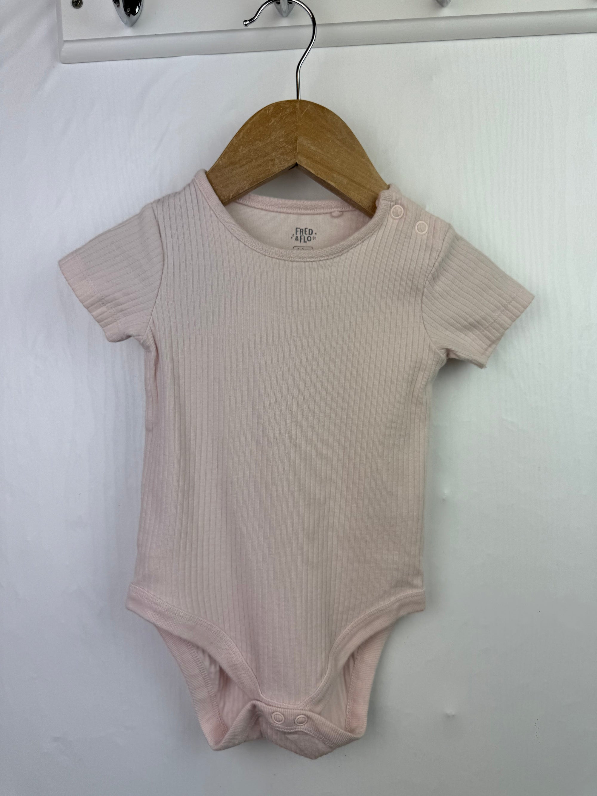 Fred & Flo Pink Ribbed Bodysuit - Girls 6 - 9 Months - Little Ones Preloved. Second Hand Children's & Preloved Baby, Kids, Girls & Boys Clothes. UK online