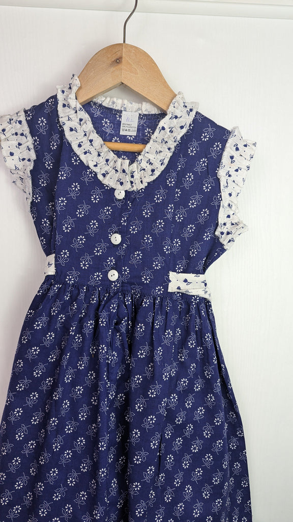 Handmade Blue & White Floral Dress - Girls 6-7 Years Little Ones Preloved Used, Preloved, Preworn Baby, Girls & Boys Clothes. Kids & Children's second hand Clothing UK Online. Cheap affordable. Brands including Next, Joules, Nutmeg Morrisons, TU, F&F, H&M.