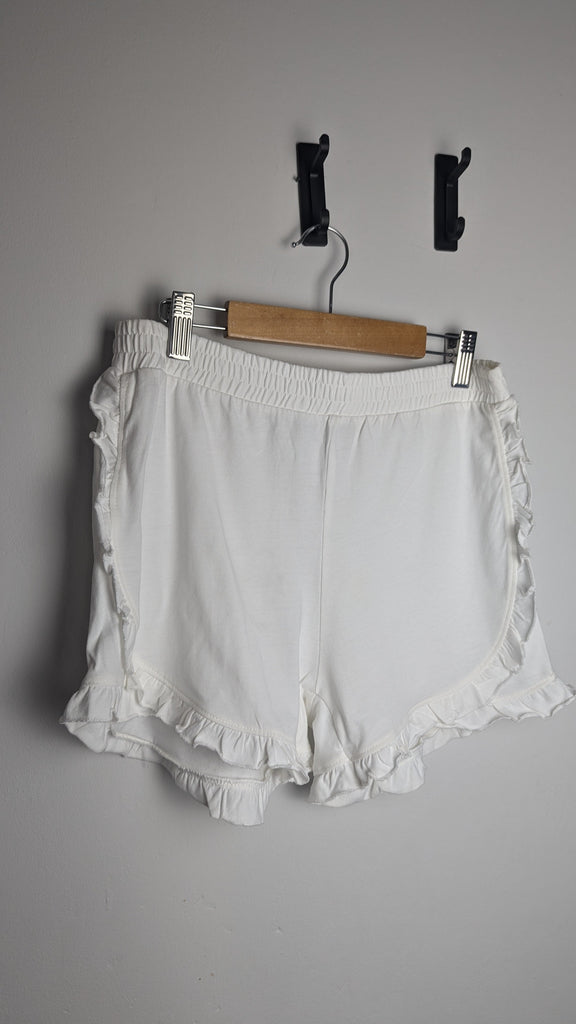 M&S White Frill Edge Shorts - Girls 12-13 Years Little Ones Preloved Used, Preloved, Preworn Baby, Girls & Boys Clothes. Kids & Children's second hand Clothing UK Online. Cheap affordable. Brands including Next, Joules, Nutmeg Morrisons, TU, F&F, H&M.