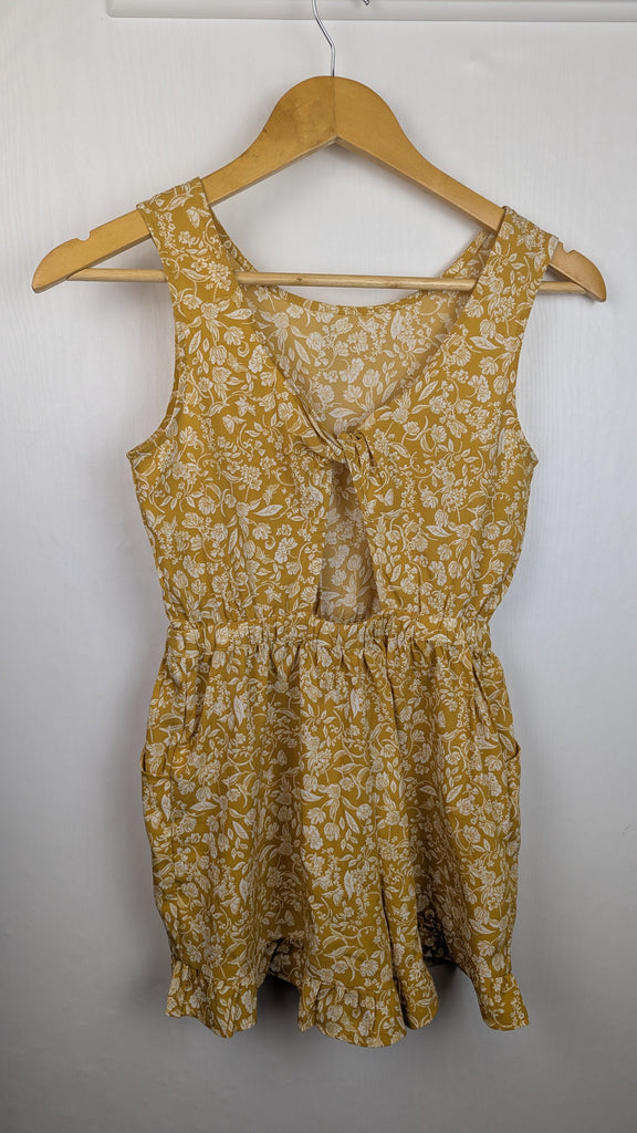 Next Mustard Floral Twist Back Playsuit - Girls 9 Years Little Ones Preloved Used, Preloved, Preworn Baby, Girls & Boys Clothes. Kids & Children's second hand Clothing UK Online. Cheap affordable. Brands including Next, Joules, Nutmeg Morrisons, TU, F&F, H&M.