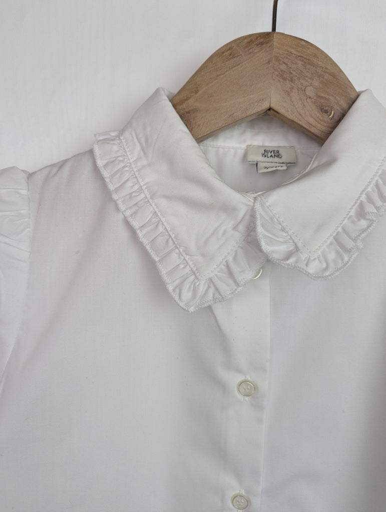 NWOT's River Island Frill Collar Shirt - Girls 7-8 Years Little Ones Preloved Used, Preloved, Preworn Baby, Girls & Boys Clothes. Kids & Children's second hand Clothing UK Online. Cheap affordable. Brands including Next, Joules, Nutmeg Morrisons, TU, F&F, H&M.