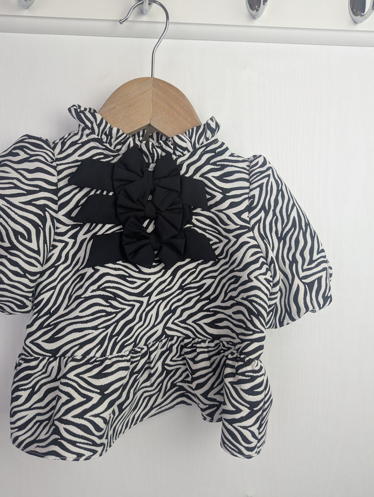 NWOT's River Island Zebra Print Top - Girls 6-9 Months Little Ones Preloved Used, Preloved, Preworn Baby, Girls & Boys Clothes. Kids & Children's second hand Clothing UK Online. Cheap affordable. Brands including Next, Joules, Nutmeg Morrisons, TU, F&F, H&M.